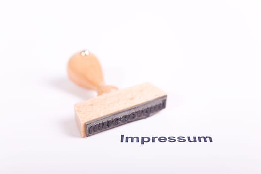 Wooden stamp with the word Imprint