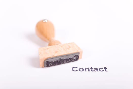 Wooden stamp with the word Contact