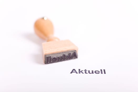 Wooden stamp with the word Current