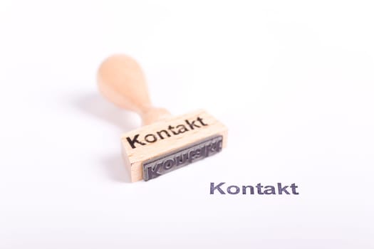 Wooden stamp with the word Contact