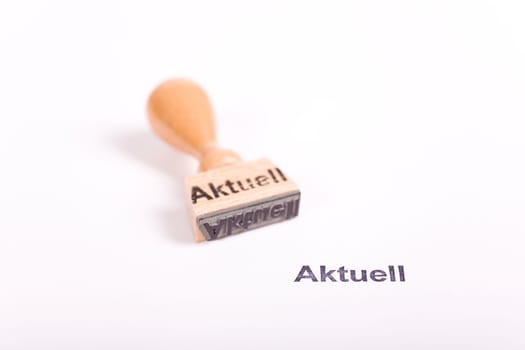 Wooden stamp with the word Current