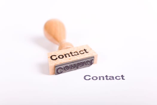 Wooden stamp with the word Contact