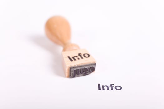 Wooden stamp with the word Info