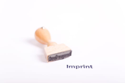 Wooden stamp with the word Imprint