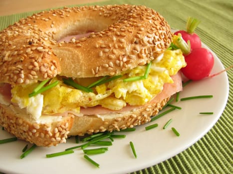 Bagel topped with ham and egg