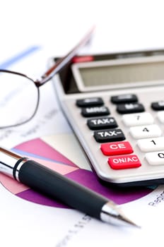 Tax calculator pen and glasses