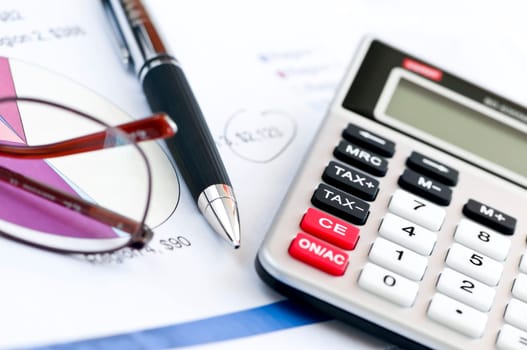 Tax calculator pen and glasses