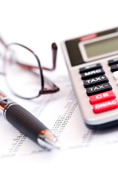 Tax calculator pen and glasses
