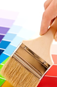 Hand holding paintbrush