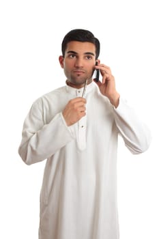 Thinking ethnic businessman on mobile phone