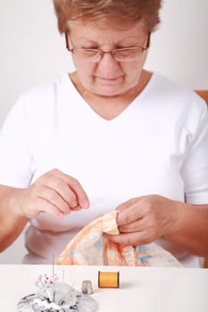 Elderly woman sewing