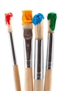 four brushes with paint