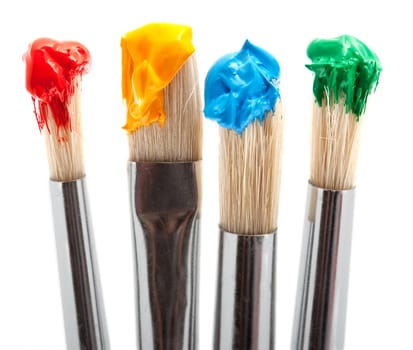 four brushes with paint