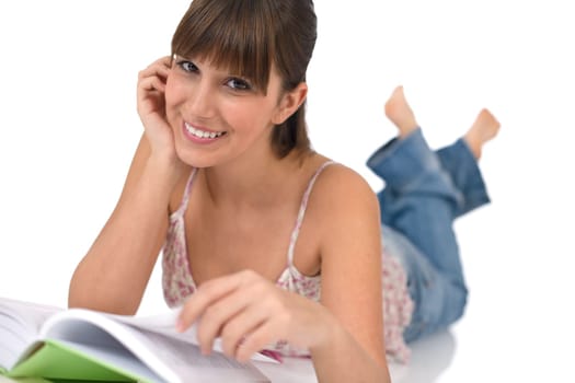 Happy female teenager reading book