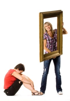 Young women posing with wooden frame