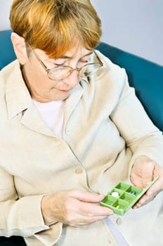 Elderly woman with pill box