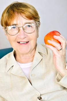 Elderly woman with apple