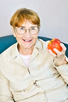 Elderly woman with apple