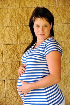 Young pregnant woman standing