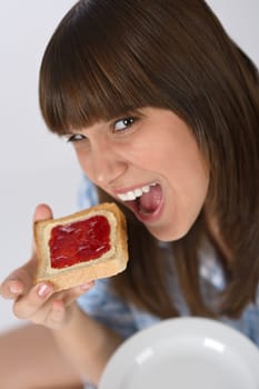 Happy teenager eating healthy toast