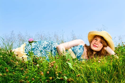 Young girl laying in meadow