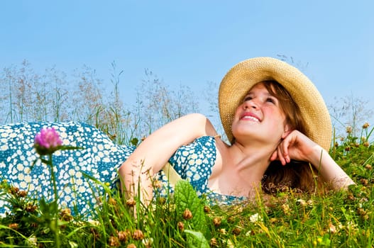 Young girl laying in meadow