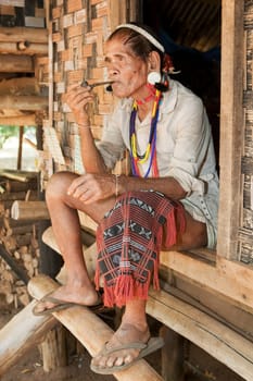 Portrait of old man with pipe