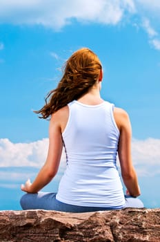 Young girl meditating outdoors
