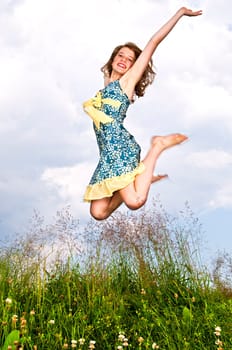 Young girl jumping in meadow
