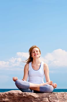 Young girl meditating outdoors