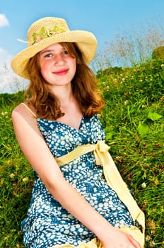 Young girl sitting in meadow