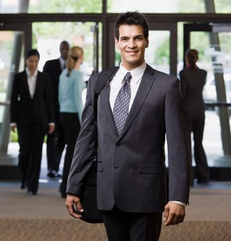 Young businessman smiling. Square framed shot.