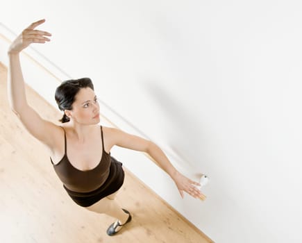 Woman dancing in dance studio. Horizontally framed shot.