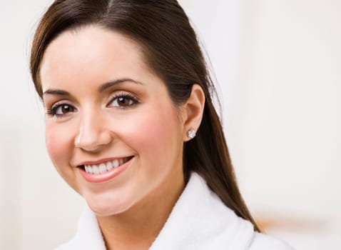 Attractive brunette smiling and looking at the camera. Horizontally framed shot.