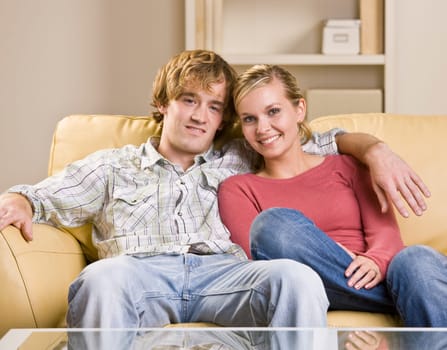 Couple sitting together on sofa