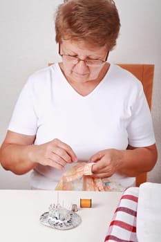 Elderly woman sewing