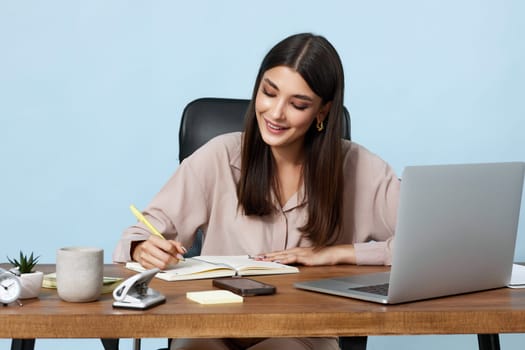 young smiling businesswoman thinking about online project while looking at laptop pc computer at workplace