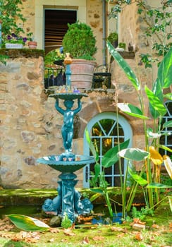 Sculpture of a child with fountain. Fountain statue in a garden