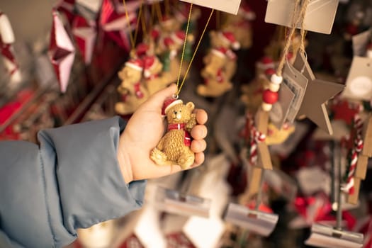 A child holds a toy bear for a Christmas tree