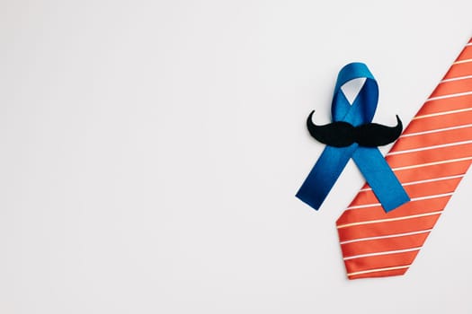 A symbol of hope and support, the blue ribbon with a mustache and necktie stands for Prostate Cancer Awareness, promoting men's healthcare and recognizing World Cancer Day.