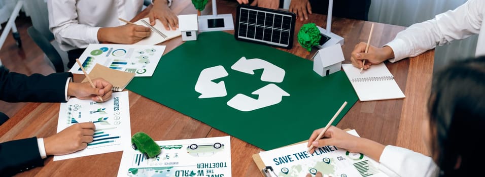 Group of business people planning and discussing on recycle reduce reuse policy symbol in office meeting room. Green business company with eco-friendly waste management regulation concept.Trailblazing