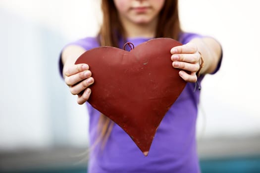 Child showing a red heart -Copy space