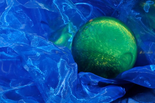 green glass ball on blue