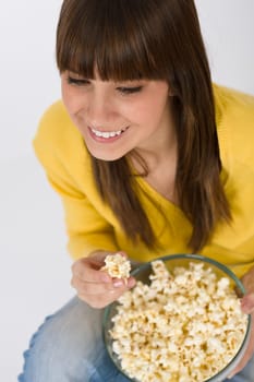 Smiling female teenager with popcorn