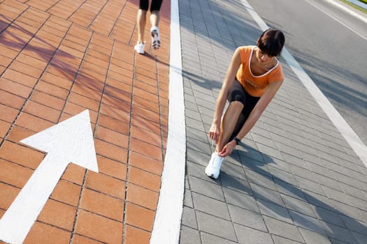 female runner tying her sport shoes.