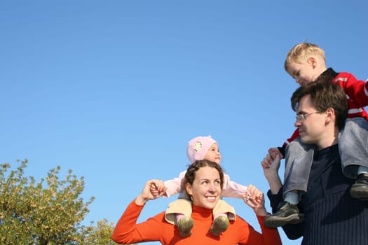 family with children on shoulders