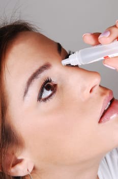 Woman with eyedrops.