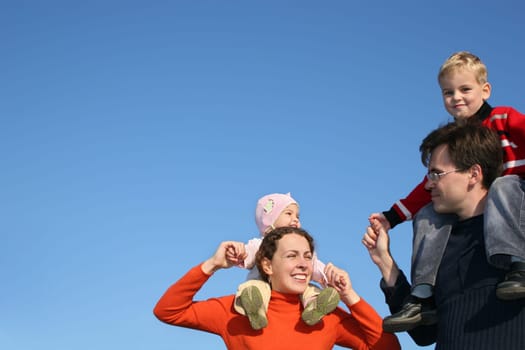 family with children on shoulders