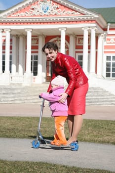 mother with baby on scooter in kuskovo moscow