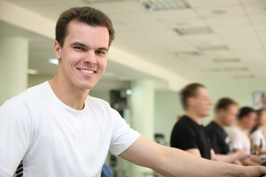 man in healthclub on exercise bicycle